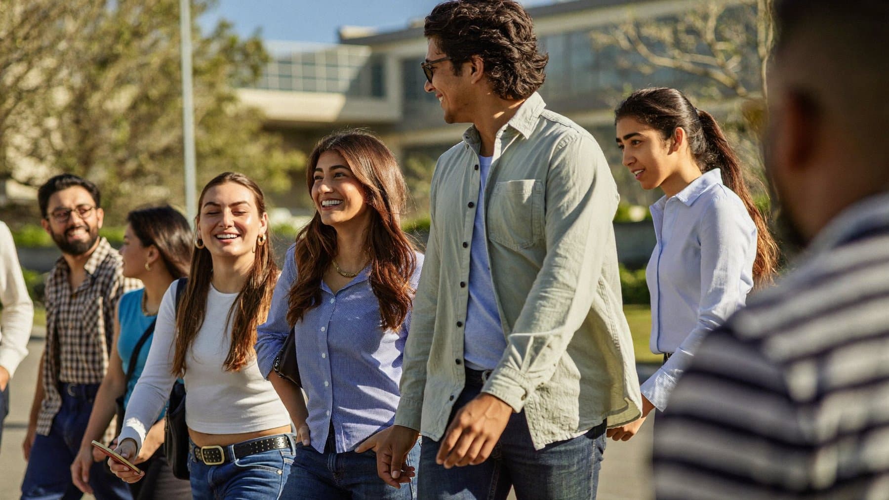A group of young Indian students and professionals walking and talking together